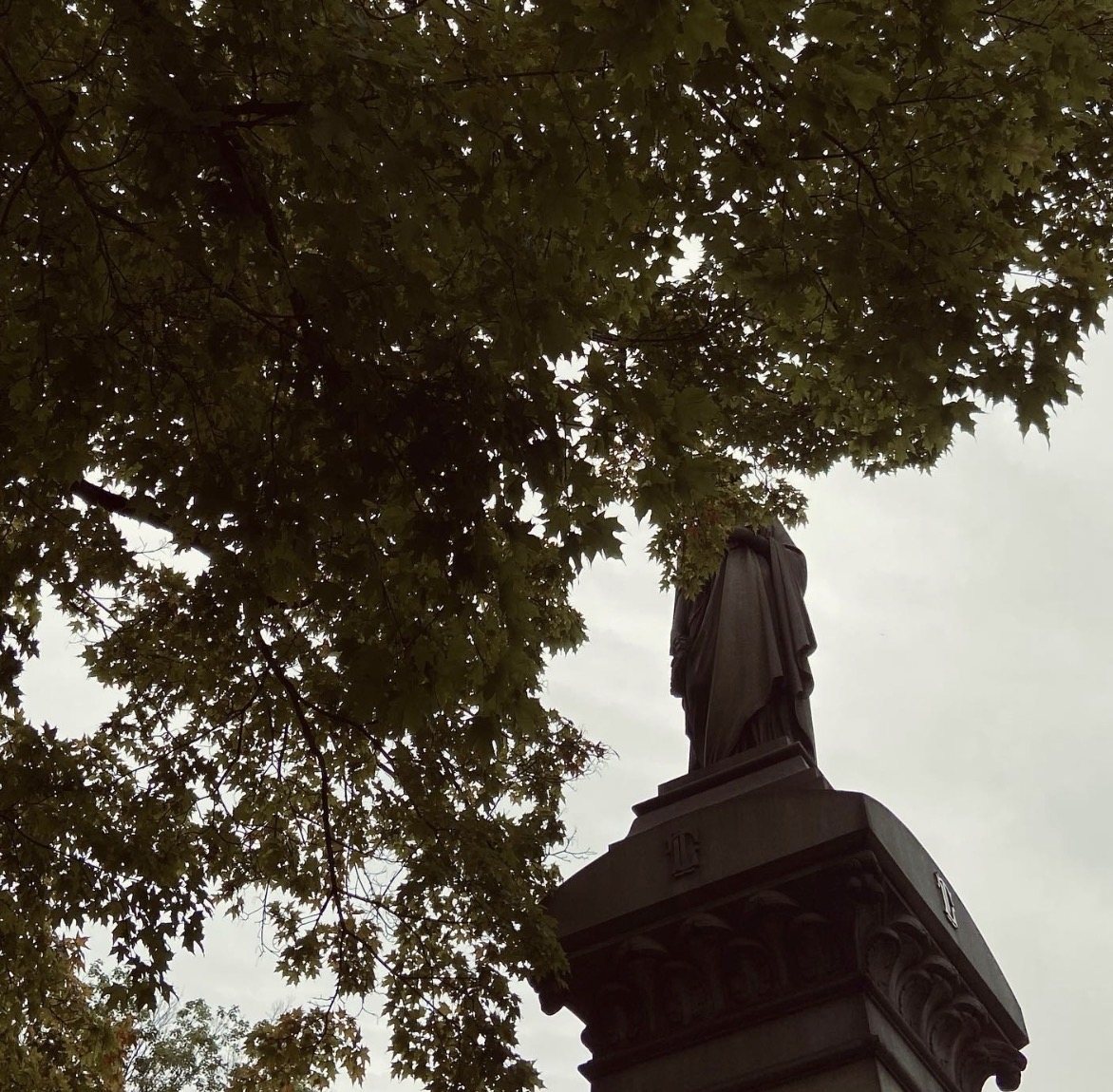 Statue Through Leaves